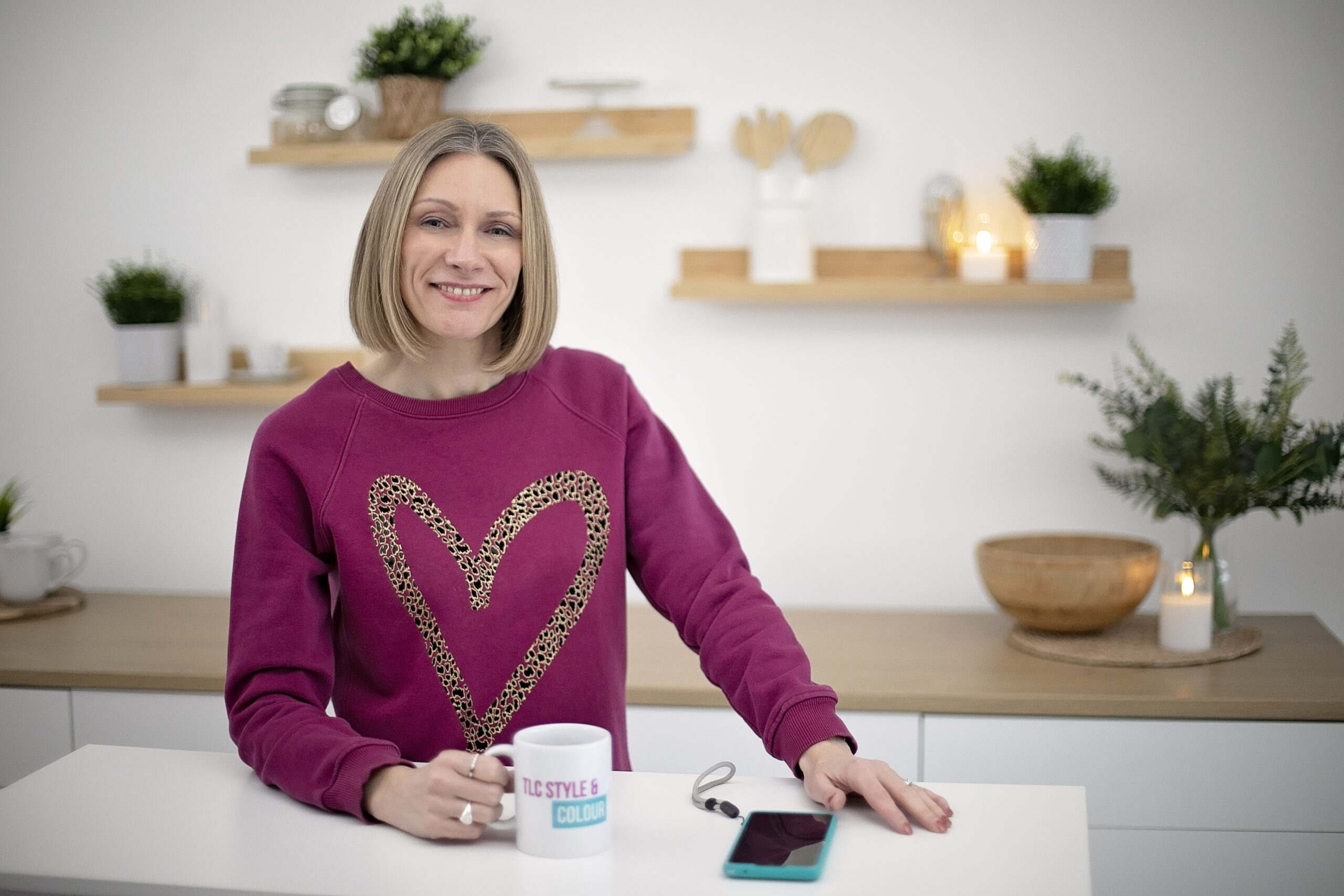 Toni with a cup of coffee and phone on the table